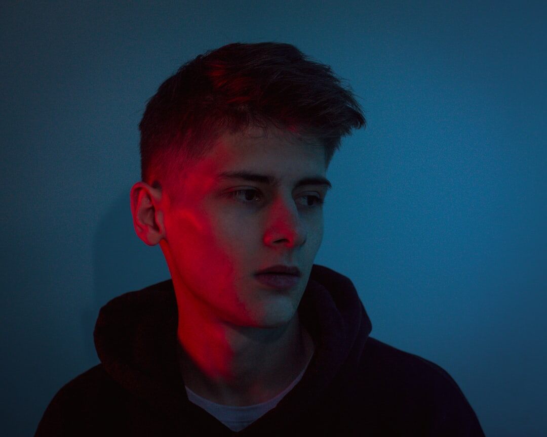 Studio portrait of a young man, video editor and colorist