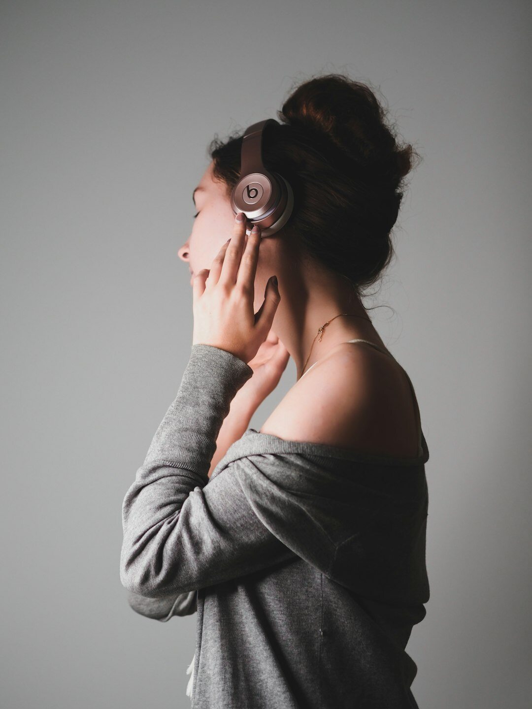 Studio portrait of a woman sound designer with headphones around her neck